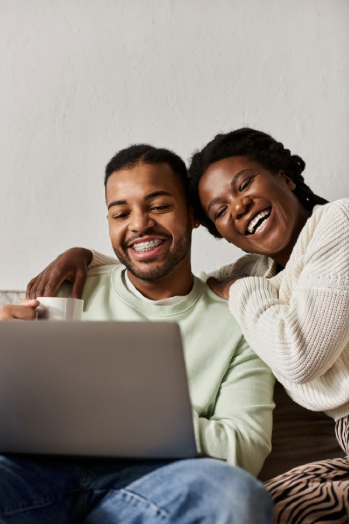 Happy couple on laptop