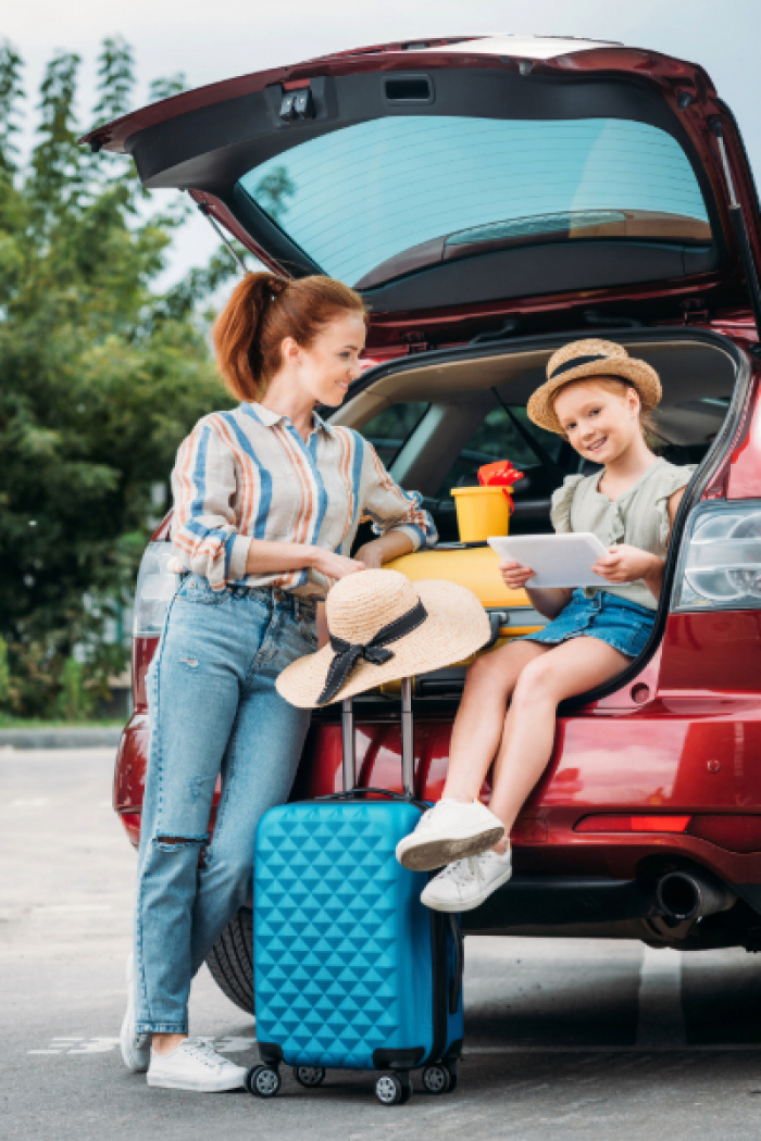 Mother and daughter traveling in their car