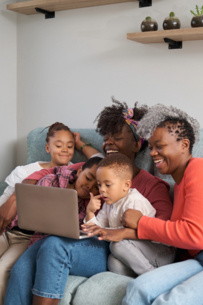 Family laughing at computer