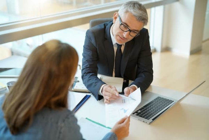 lender and business owner reviewing papers