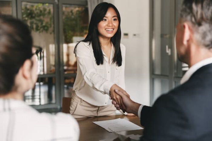 woman and man shaking hands