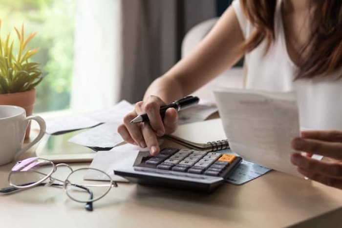 Woman using calculator