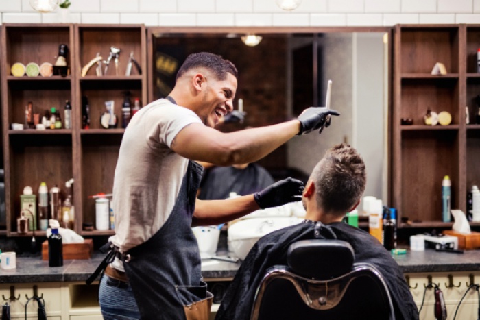 Barber Shop employee laughing with customer