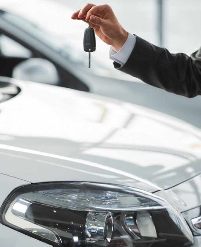Person holding the keys to their business vehicle.