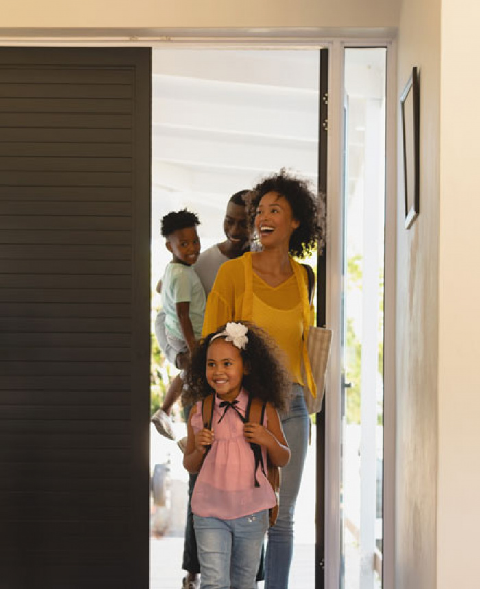 Family walking into their new home.