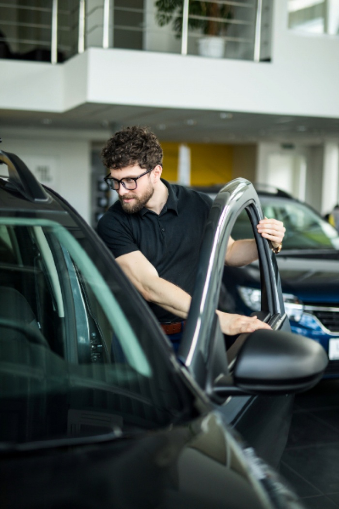 Young adult checking out new car