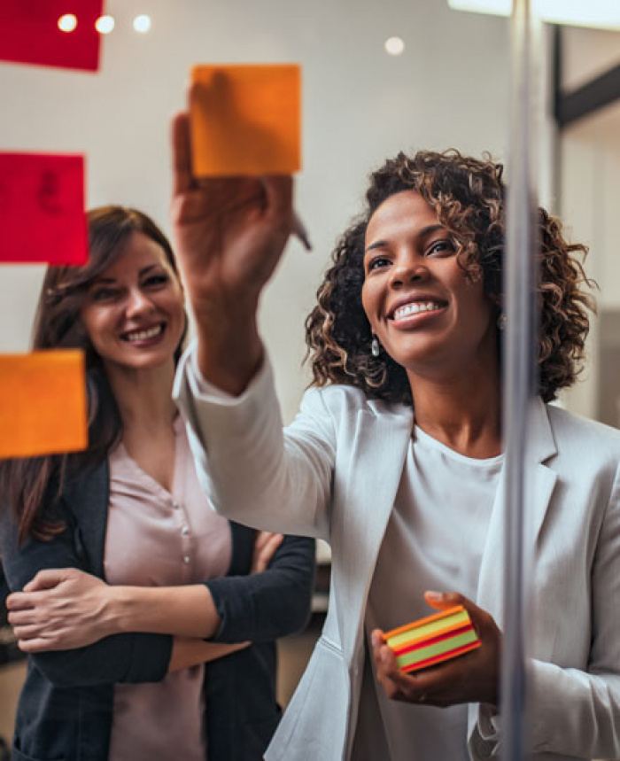 Two female, business owners planning on how to expand their company.