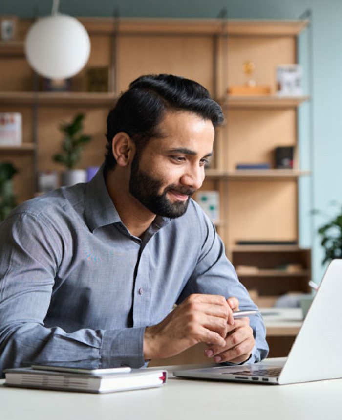 Man learning from his computer that he had been approved for a Personal Line of Credit
