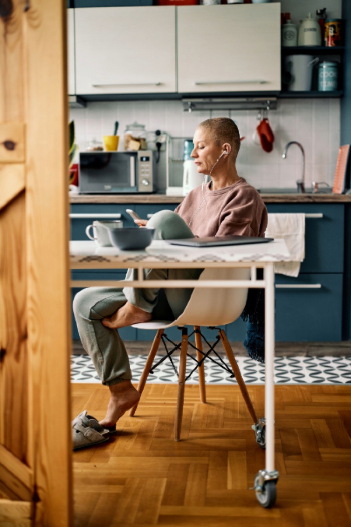 Woman reading phone in kitchen