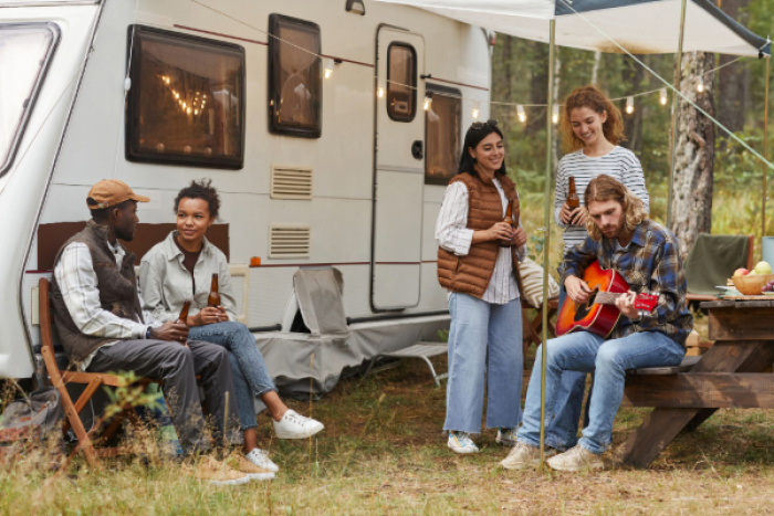 Group of friends camping with their RV