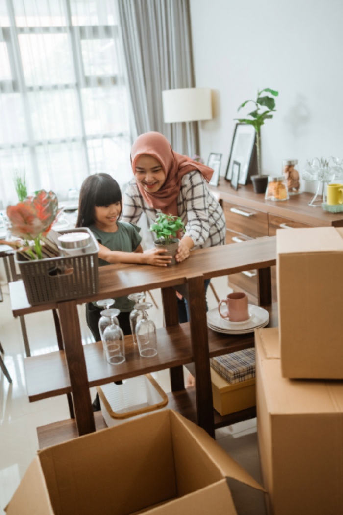 Mother decorating home with daughter