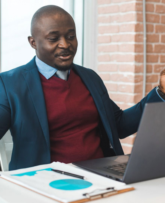 Happy business man who is reading his online banking statement.