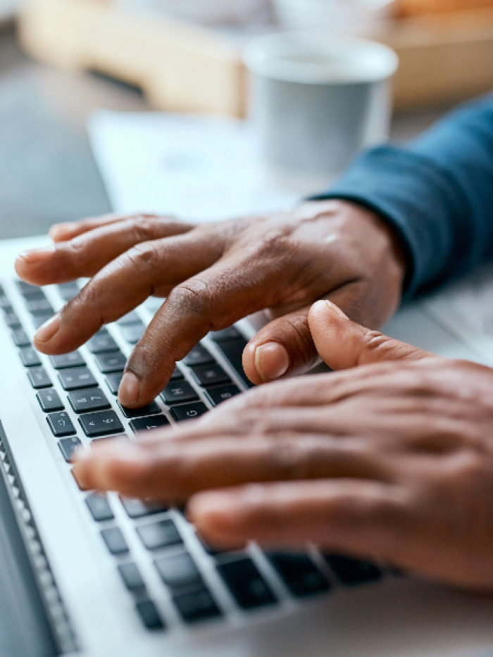 Hands typing on keyboard