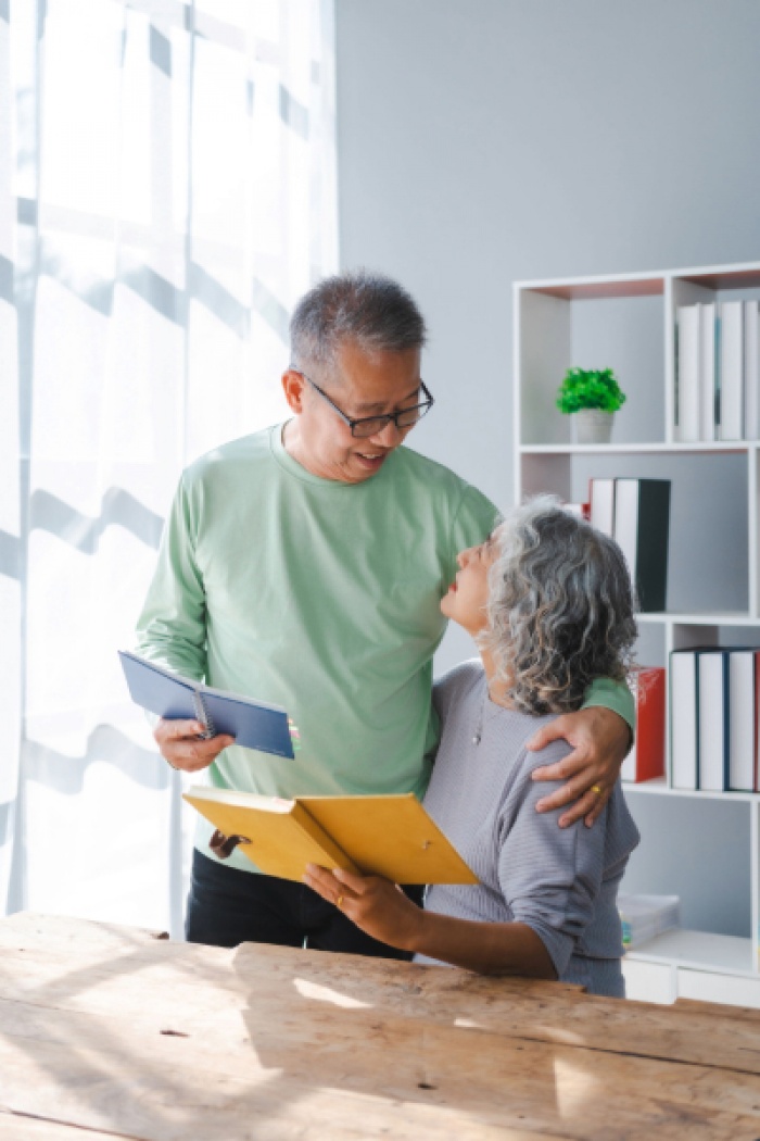 Elderly couple looking at each other lovingly