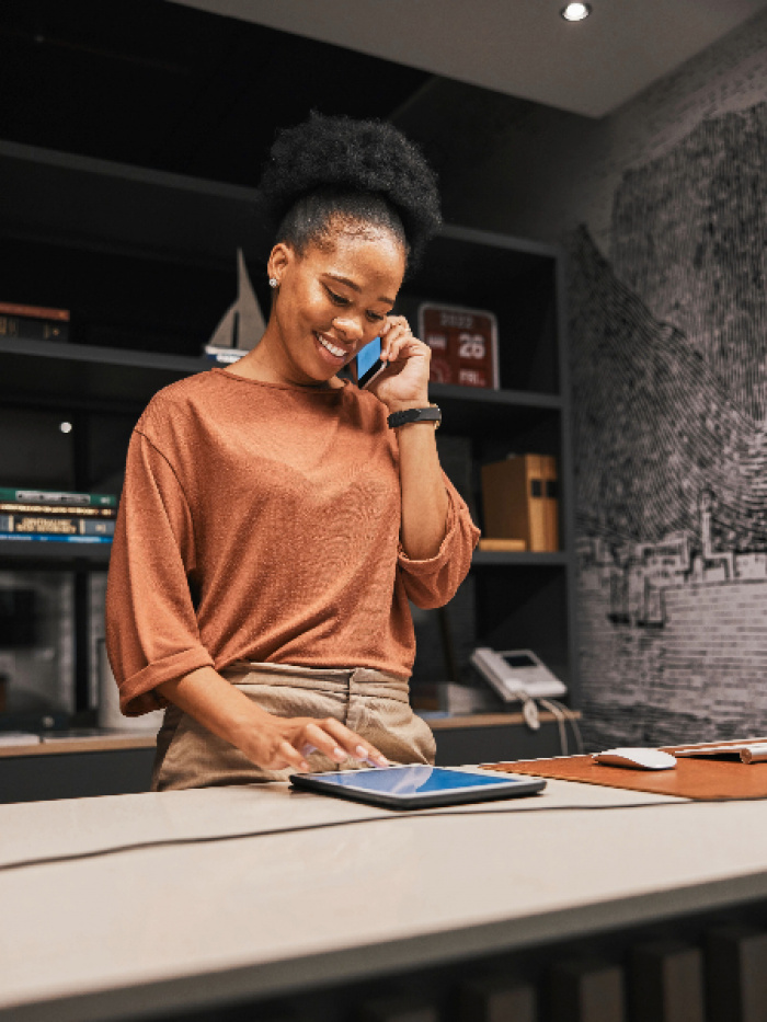 Woman using phone and tablet