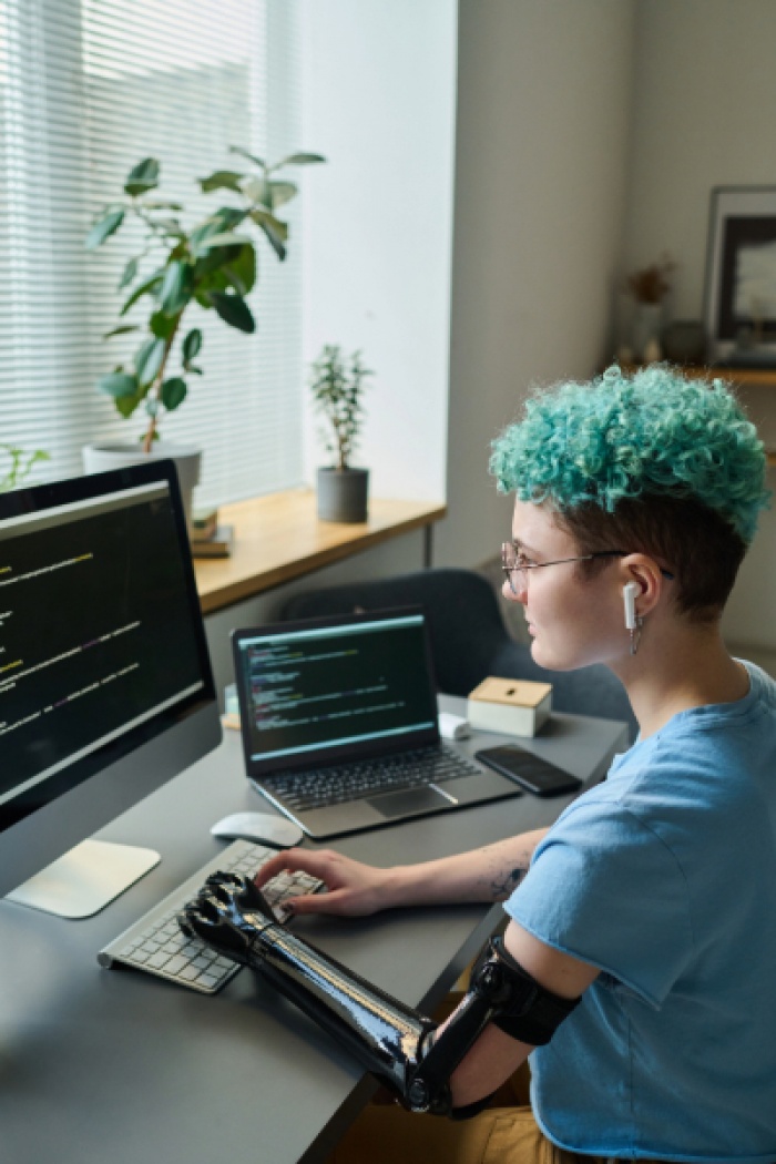 Young woman coding on computer