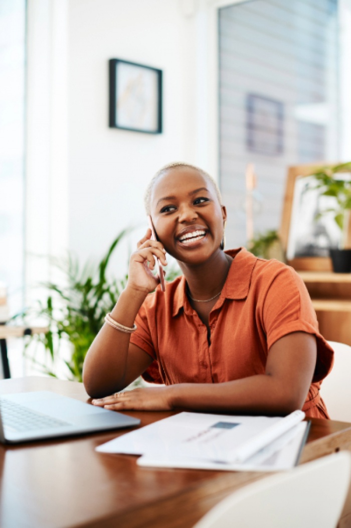 Happy business woman on the phone