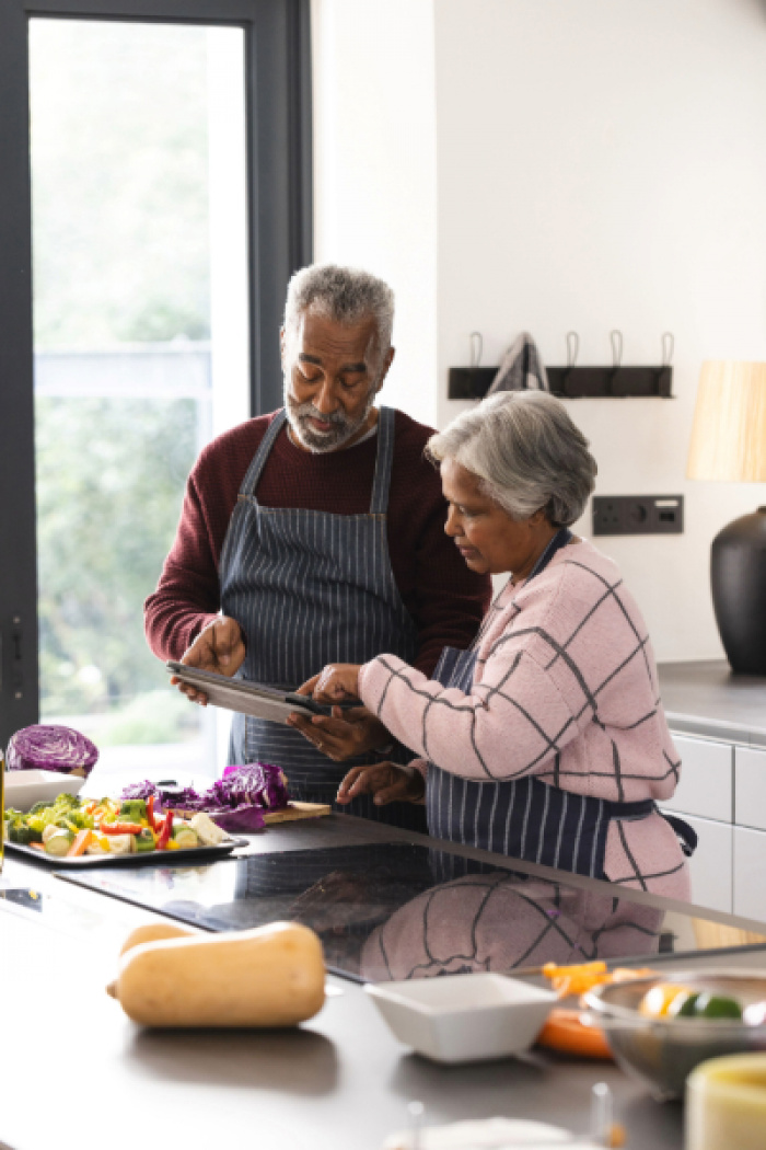 Retired couple cooking together