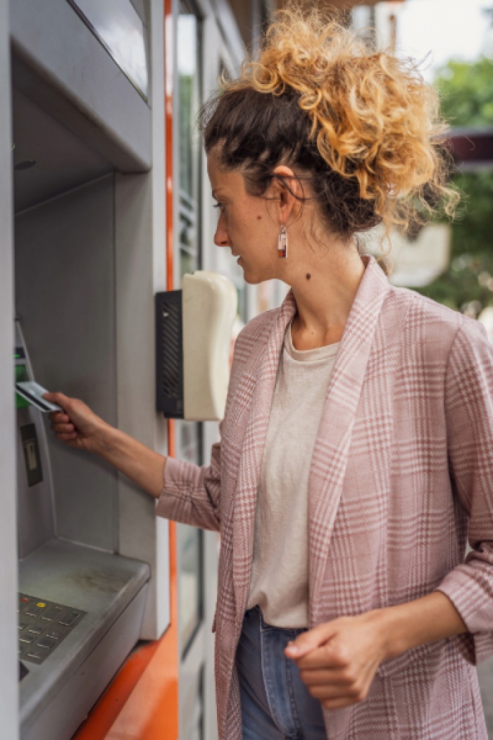 Woman using ATM machine