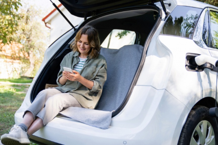 Woman charging her hybrid car