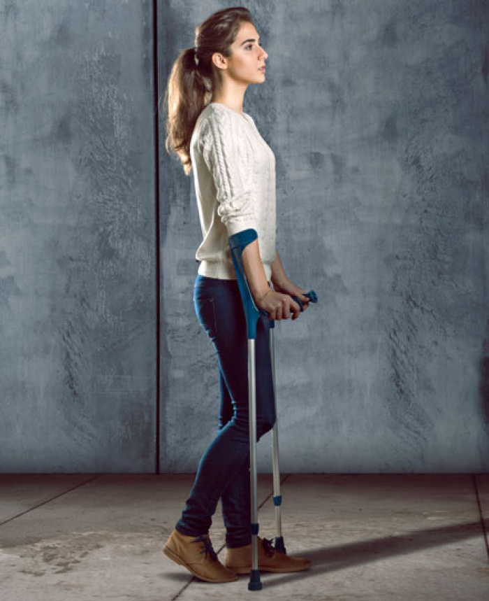 Woman walking with crutches