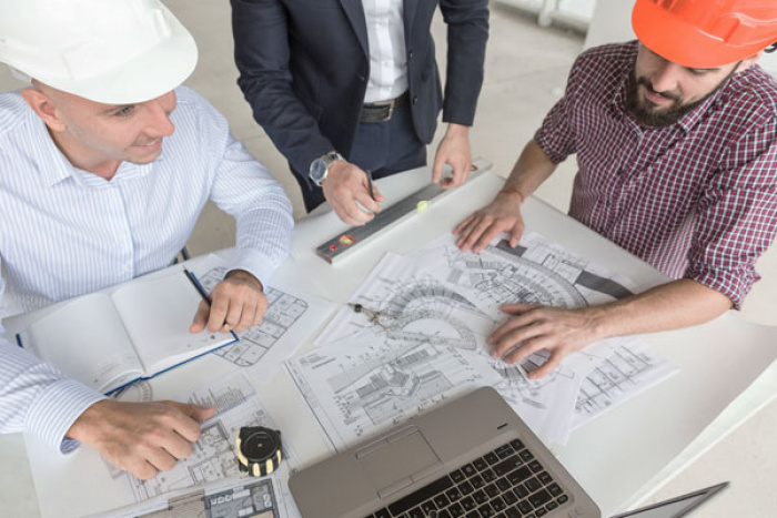 Business reviewing their construction plans.