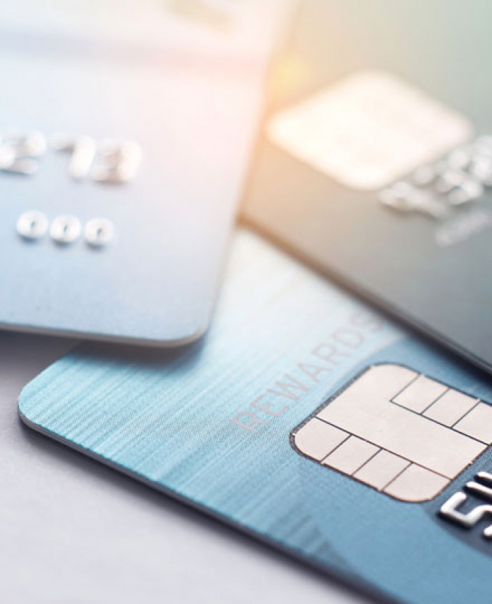 Three credit cards haphazardly stacked