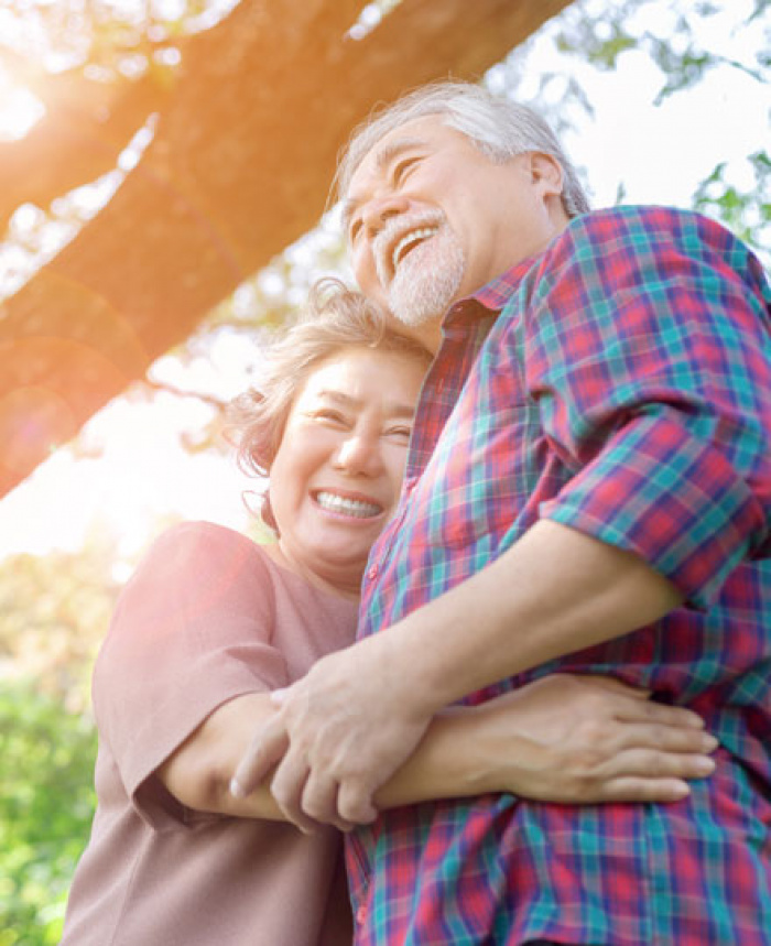 Happy couple embracing under a tree