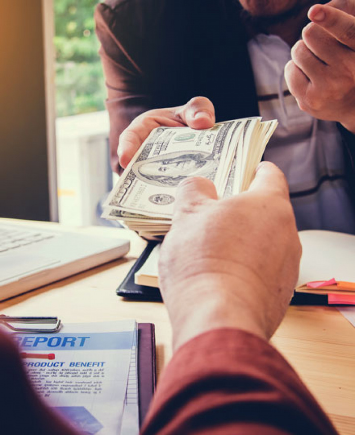 Lender handing cash to borrower