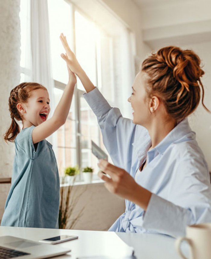 Mom and daughter celebrating their online shopping using a FCFCU Visa credit card