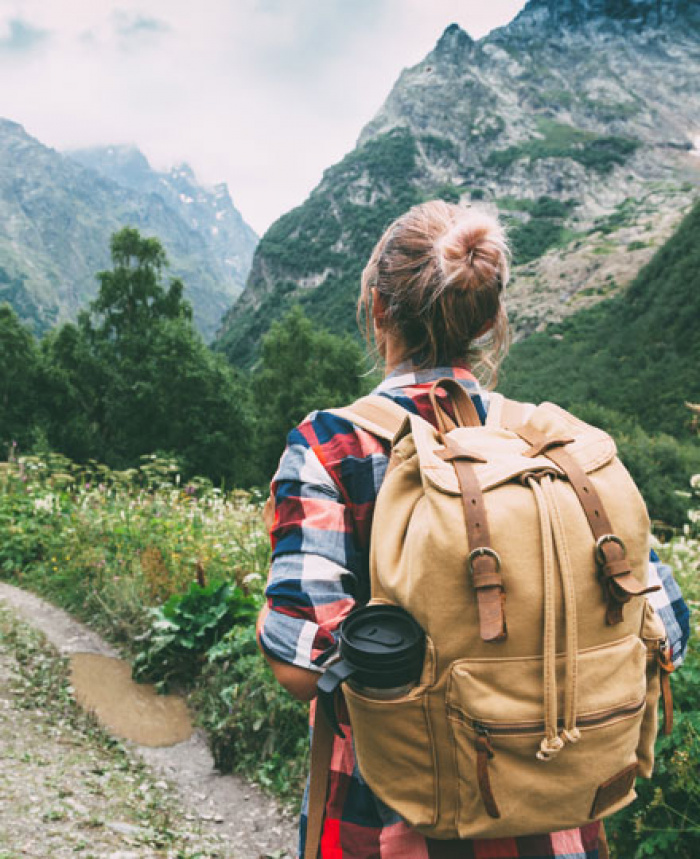 Woman with backpack on mountainous hiking trail