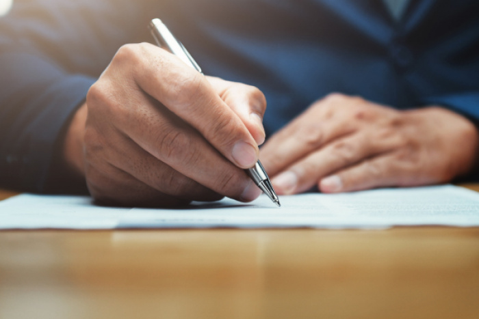 man writing a letter