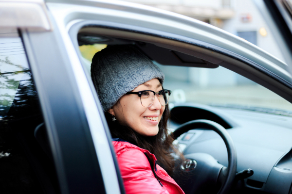 Woman smiling in her new car