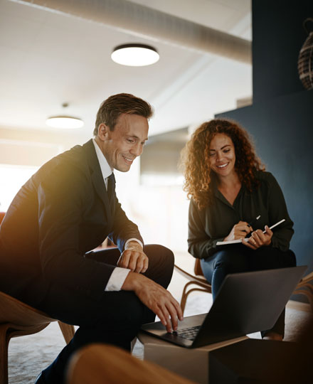 Two business partners reviewing their proposals.