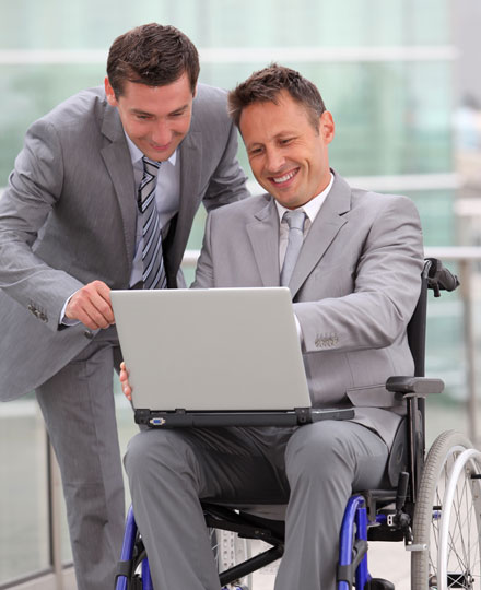 Two business partners reviewing their banking statements online.
