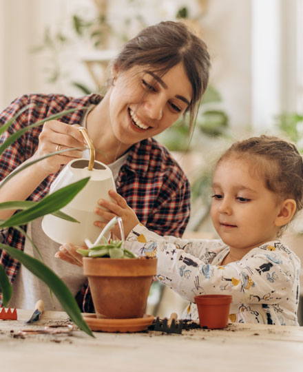 Mother and child gardening together.