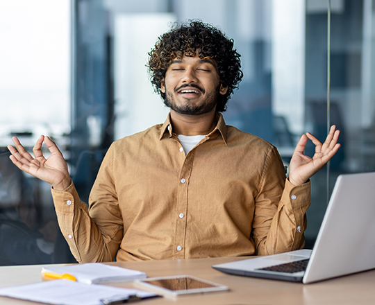 Man meditating while doing taxes