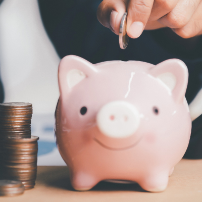 coin being placed in piggy bank
