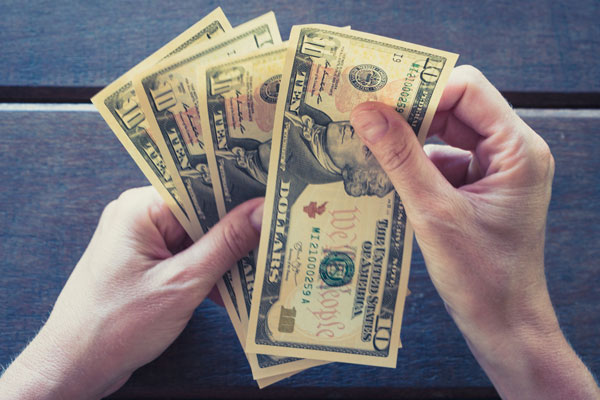 counting four ten dollar bills