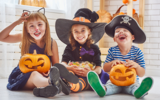 kids in halloween costumes laughing