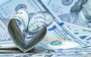 100 bill folded into a heart shape